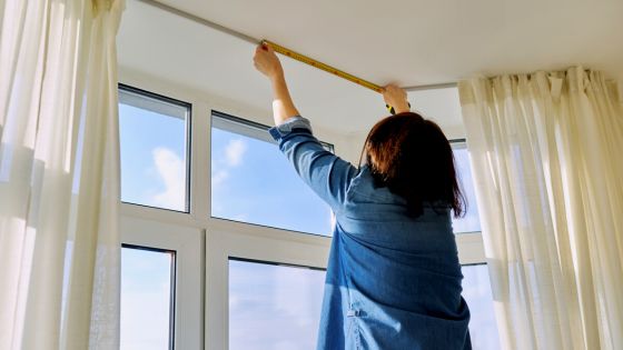 woman measuring a bay window